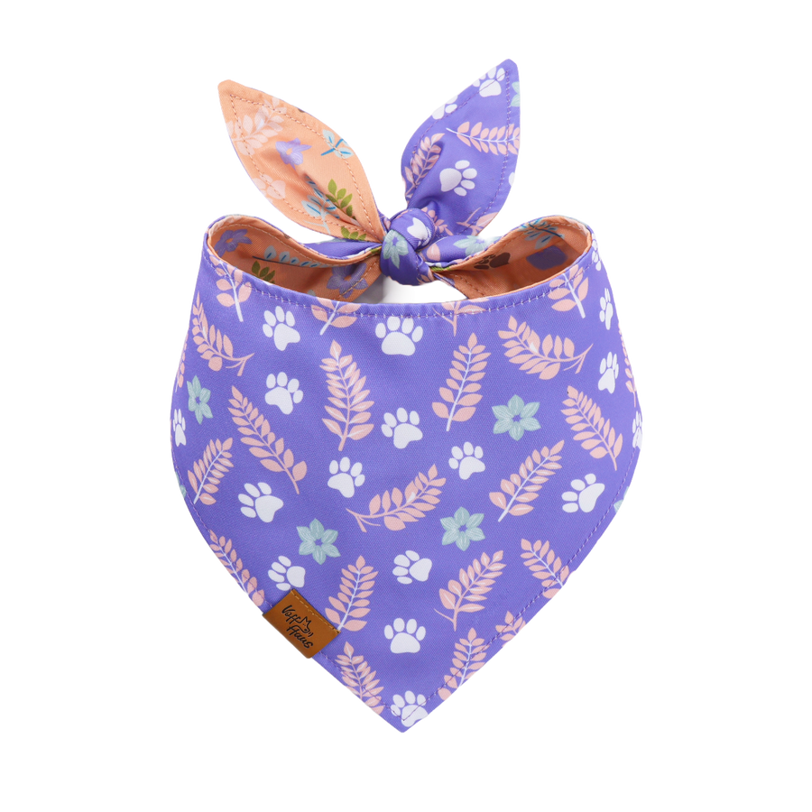 Purple bandana with floral and paw print patterns on a white background