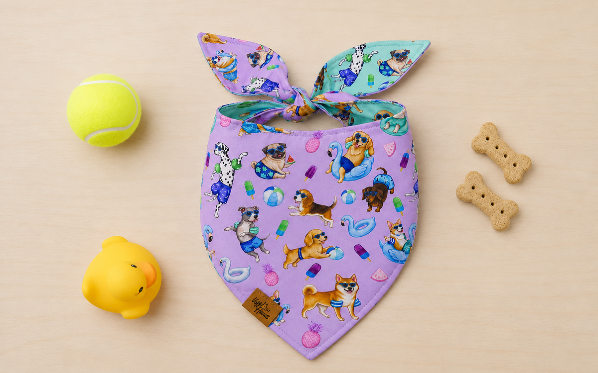 The Endless Pawty reversible dog bandana tied flat, lavender side with pups riding pool floats
