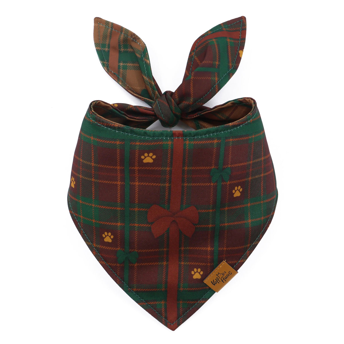 The Bark The Halls reversible dog bandana tied and laid flat, showing the green and red plaid reverse side