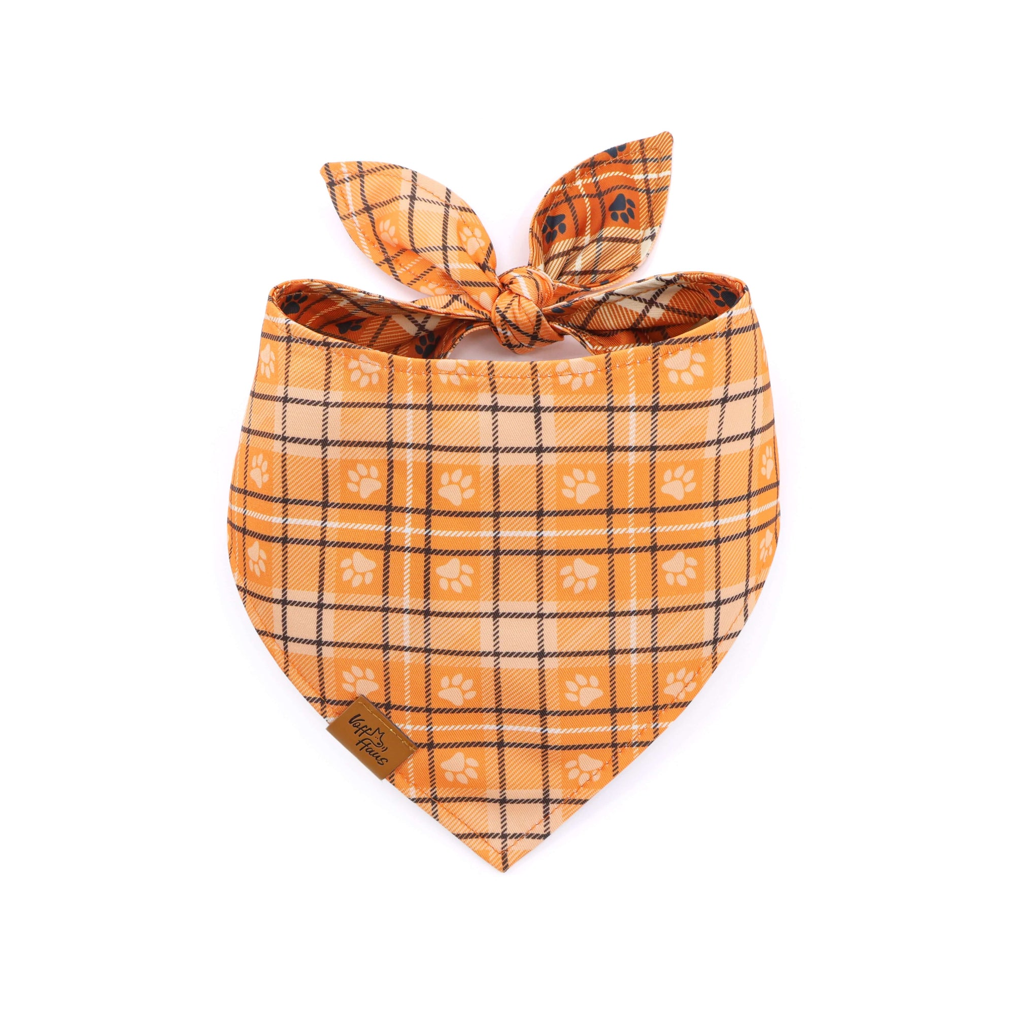 Plaid dog bandana with paw prints on a white background