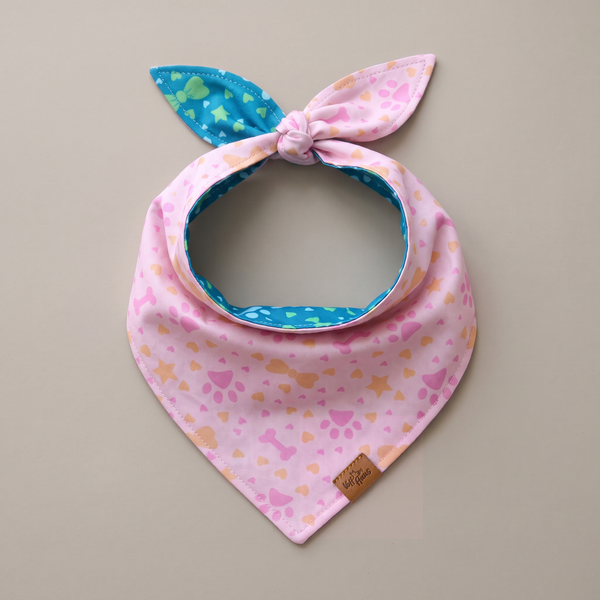 Pawprints & Love reversible dog bandana, Blush Paws side, tied flat lay